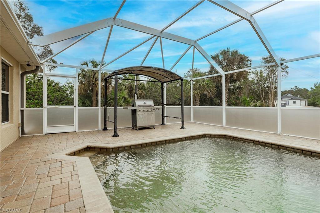 View of pool with a grill gazebo
