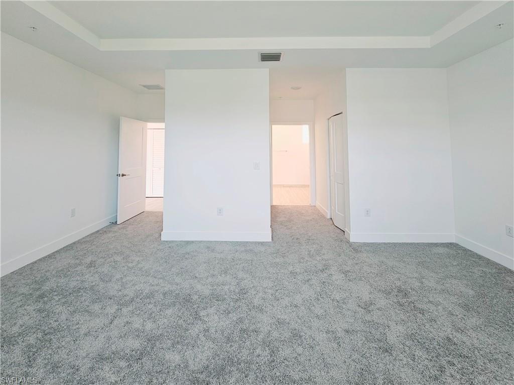 Unfurnished room featuring carpet flooring and baseboards