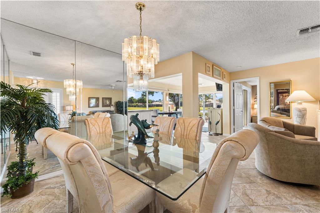 Formal dining area has views of the lake and golf course.
