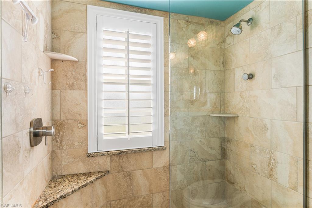 Master bath offers a walk in shower, seating, seamless glass enclosure.  Plantation shutters.
