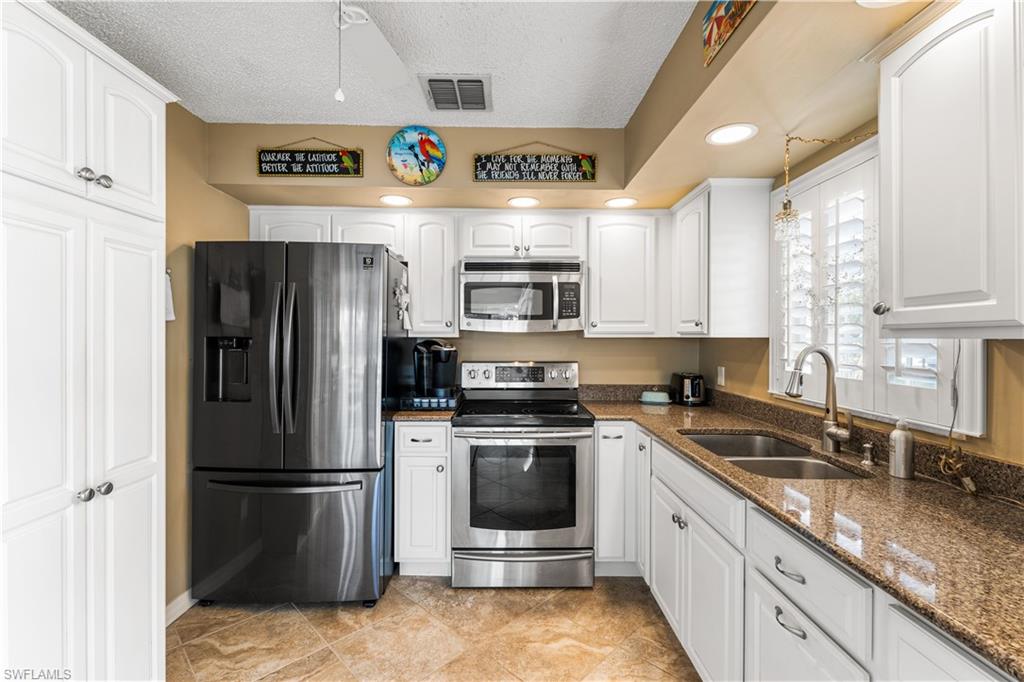 Granite countertops, stainless steel appliances, additional cabinetry. Plantation shutters.
