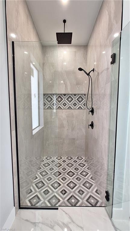 Unfurnished room featuring light marble finish flooring and ceiling fan