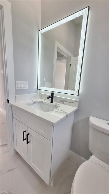 Corridor featuring light marble finish flooring and recessed lighting