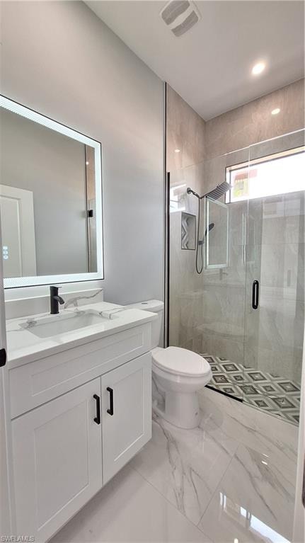Spare room featuring light marble finish flooring, a ceiling fan, a raised ceiling, and recessed lighting