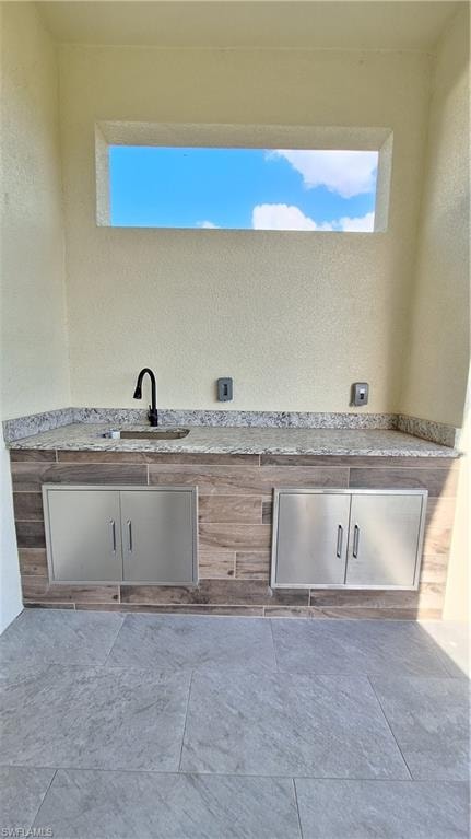 Bathroom with a stall shower and marble finish floors