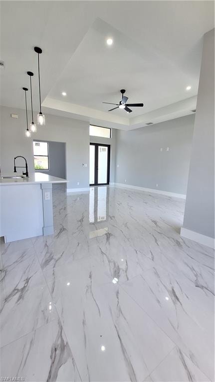 Kitchen featuring appliances with stainless steel finishes, light marble finish flooring, white cabinetry, light stone countertops, and recessed lighting