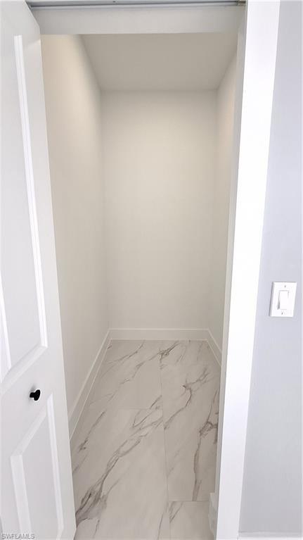 Bathroom with light marble finish flooring and vanity