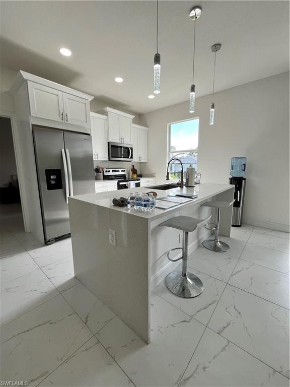 Kitchen with white cabinets, recessed lighting, refrigerator, stove, and marble finish floor