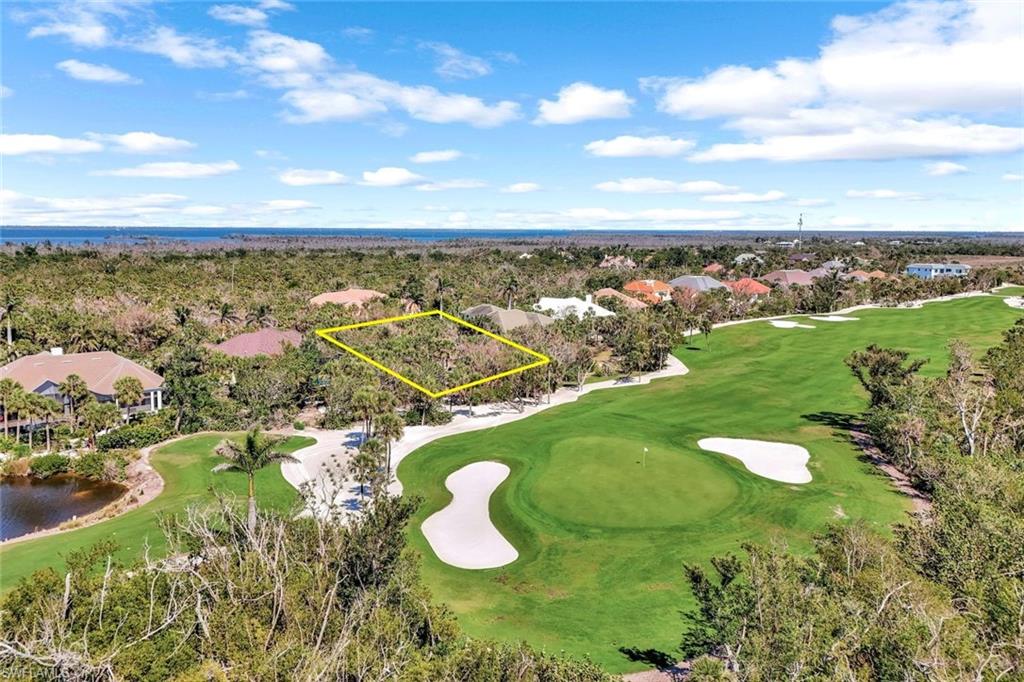 Drone / aerial view with view of golf course and a water view