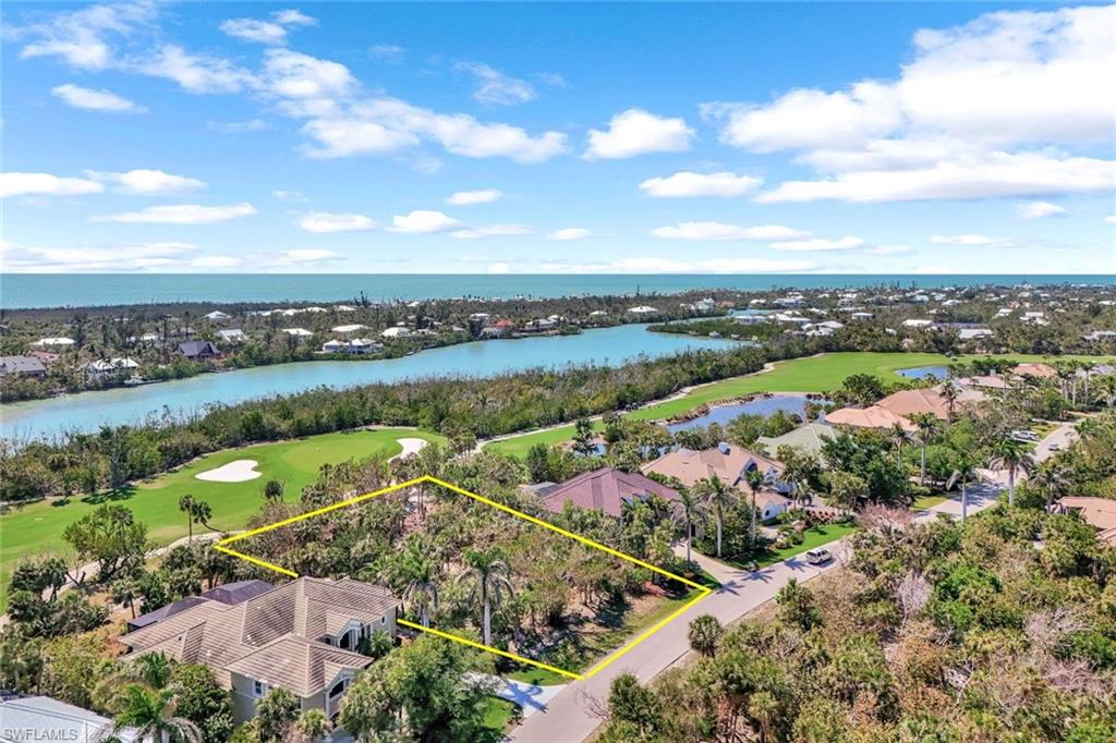 Birds eye view of property featuring golf course view and a water view