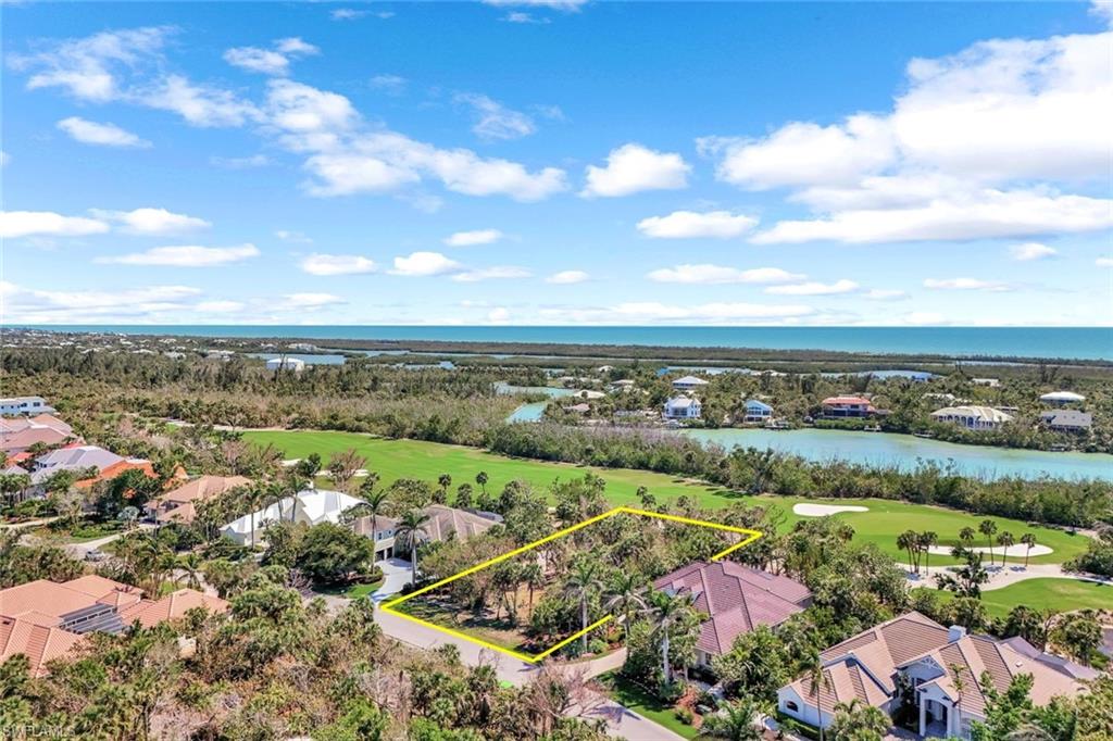 Drone / aerial view featuring view of golf course and a water view
