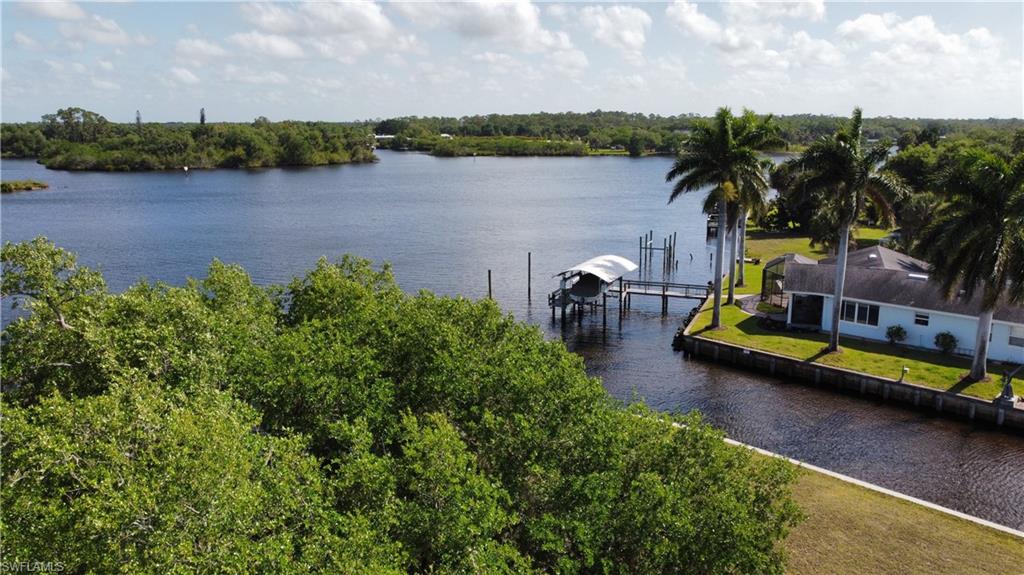 Property view of water featuring boat lift and a boat dock