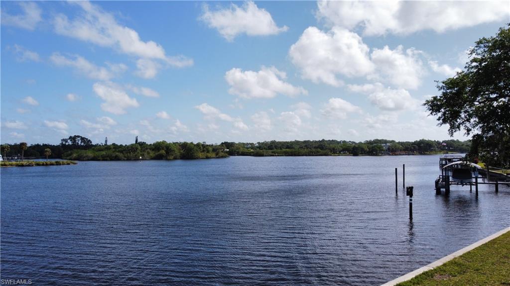 View of water feature with boat lift and a boat dock