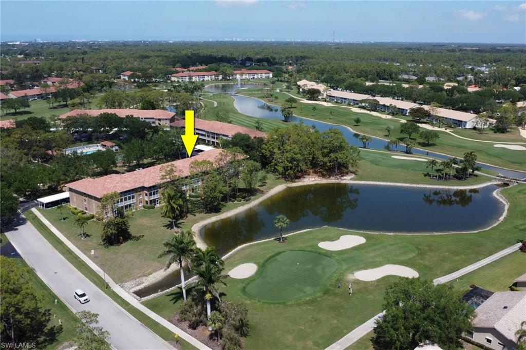 Birds eye view of property featuring view of golf course and a water view