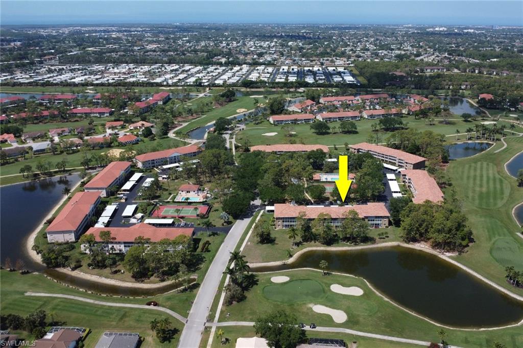 Aerial view with view of golf course and a water view