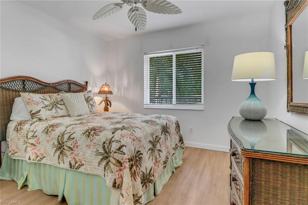 Bedroom featuring baseboards, wood finished floors, and ceiling fan