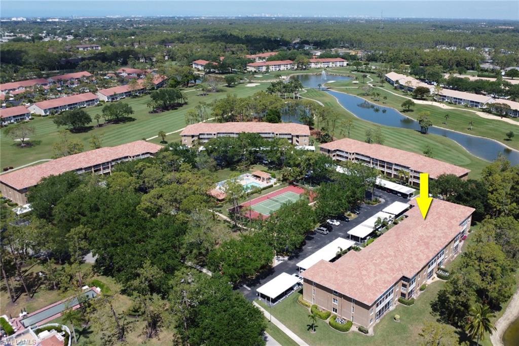 Drone / aerial view featuring golf course view and a water view