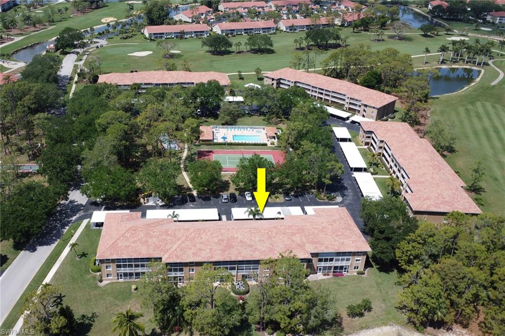 Drone / aerial view featuring golf course view and a water view