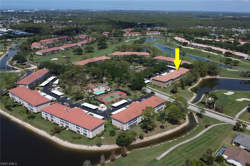 Aerial view with golf course view and a water view