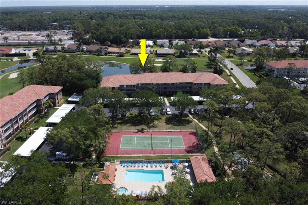 Birds eye view of property with a water view