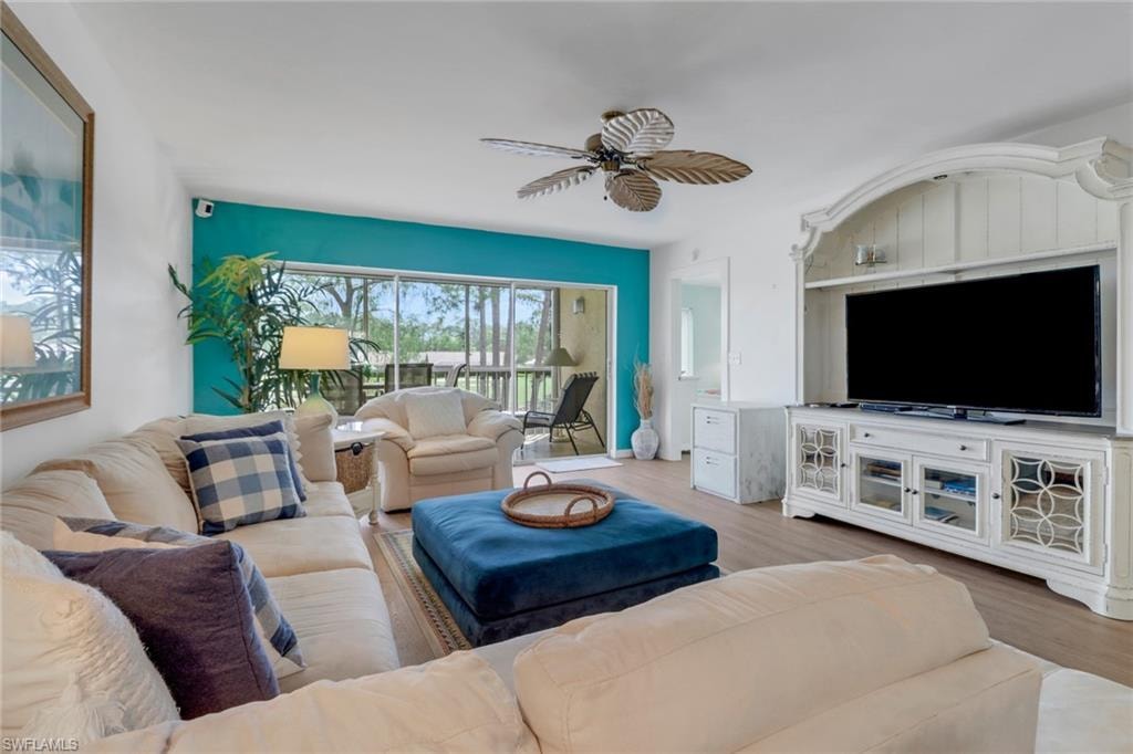 Living room with ceiling fan and wood finished floors