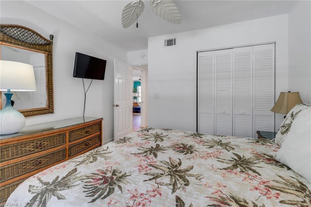 Bedroom with visible vents, a closet, and a ceiling fan