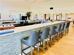 Bar featuring light wood finished floors