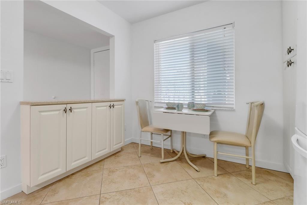 Dining space with baseboards and light tile patterned floors