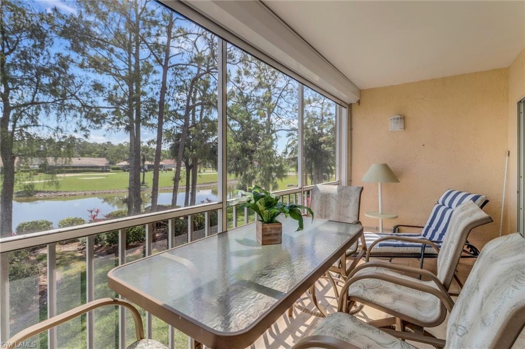 Sunroom / solarium with a water view