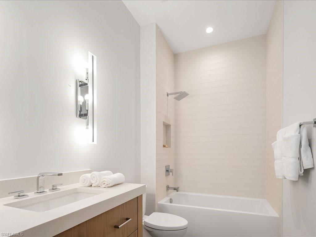 Full bath with toilet, vanity, and washtub / shower combination