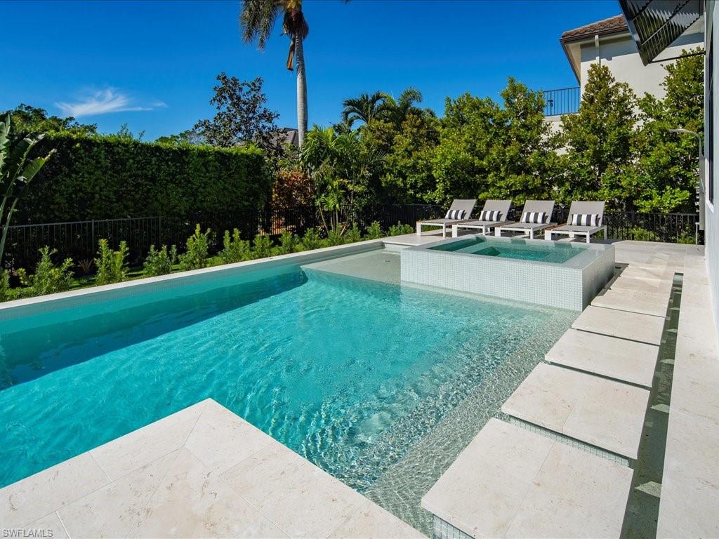 View of pool with a fenced backyard, an in ground hot tub, a patio, and a fenced in pool
