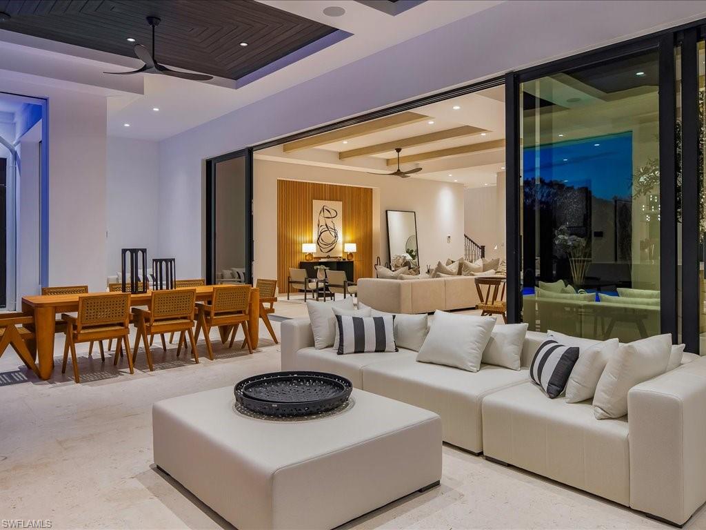 Living area with beamed ceiling, recessed lighting, and a ceiling fan