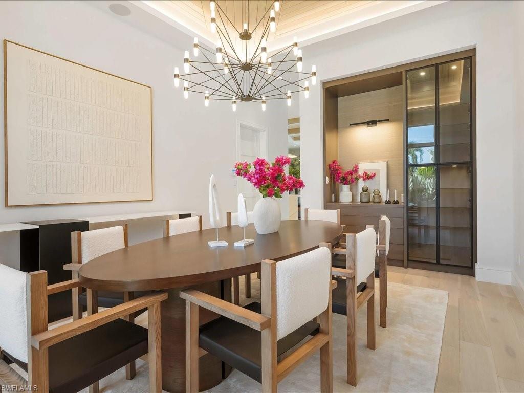 Dining area with a notable chandelier and light wood-style floors