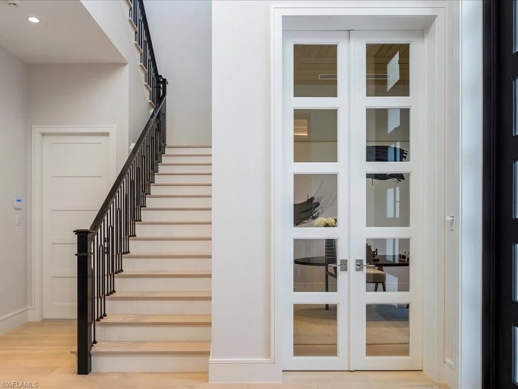 Staircase featuring french doors, recessed lighting, baseboards, and wood finished floors