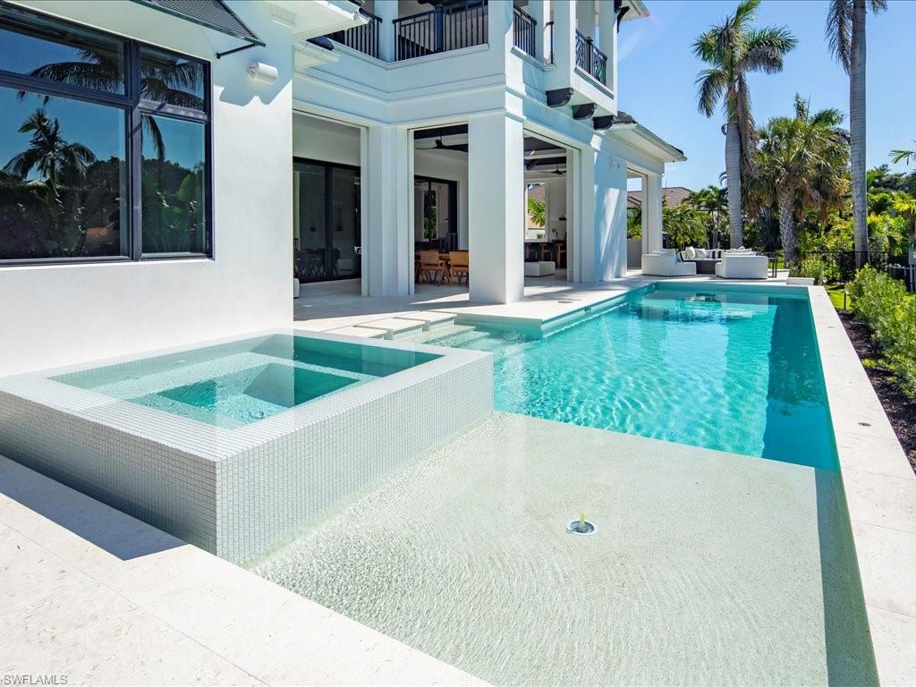 Pool with an in ground hot tub, an outdoor living space, and a patio