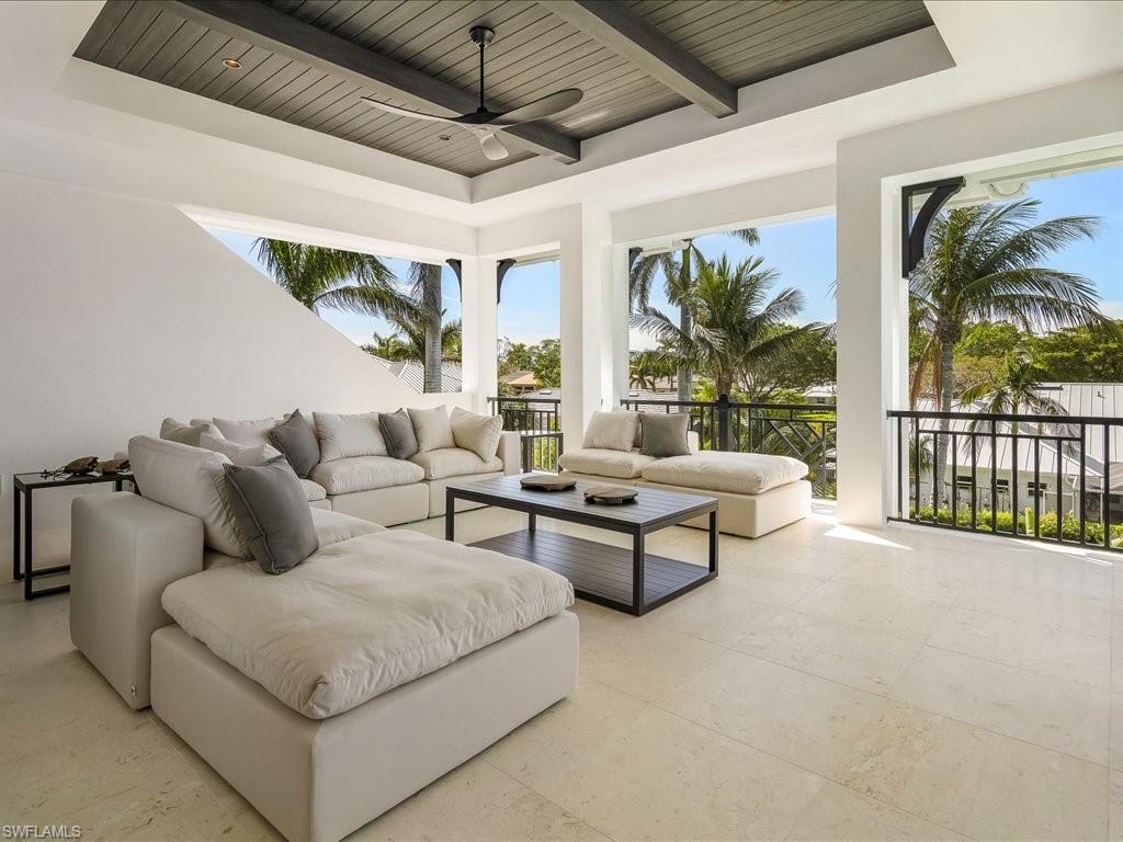 View of patio with an outdoor hangout area and a ceiling fan