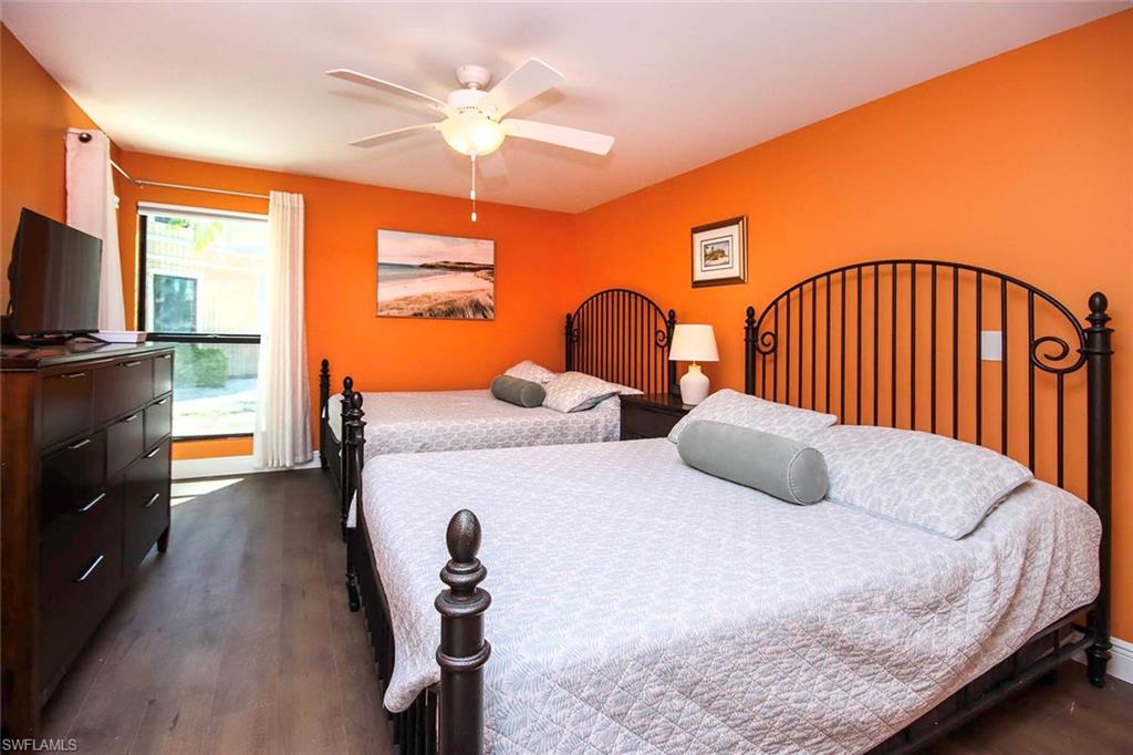 Bedroom featuring a ceiling fan and dark wood-style flooring