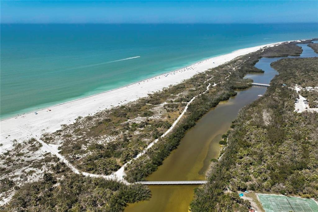 Drone / aerial view featuring a water view and a beach view