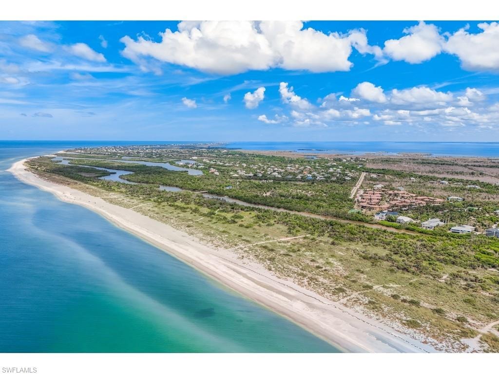 Bird's eye view featuring a water view and a beach view