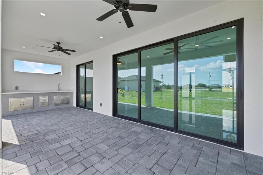 View of patio / terrace featuring a sink, area for grilling, and a ceiling fan