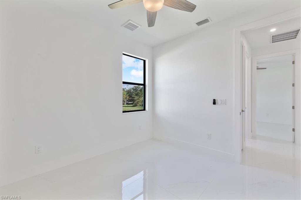 Spare room featuring baseboards and visible vents