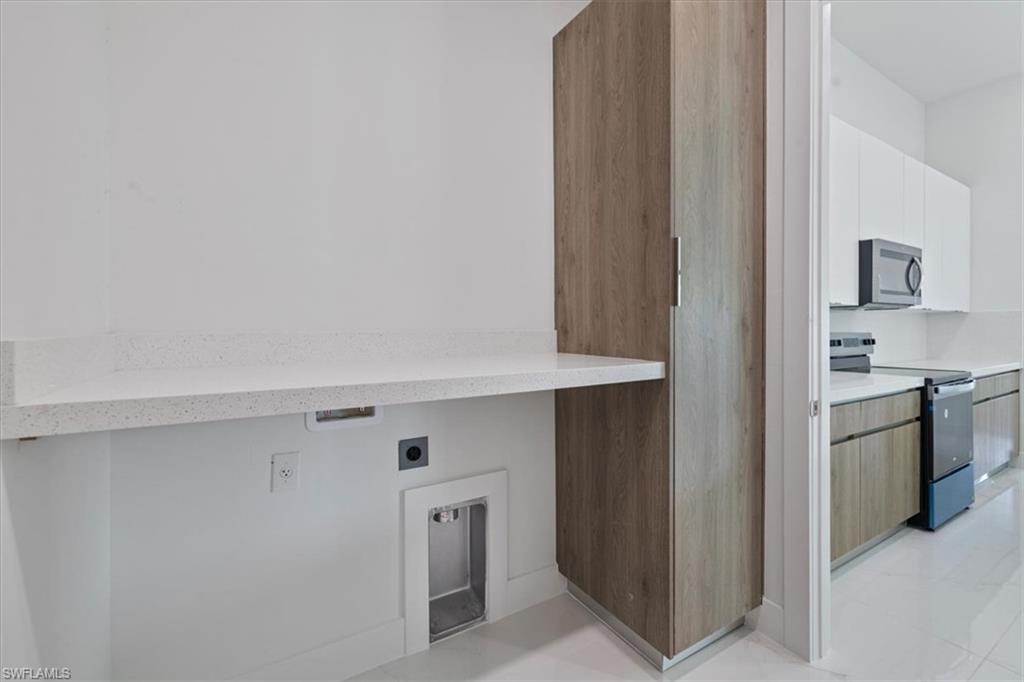 Laundry area featuring hookup for an electric dryer and laundry area