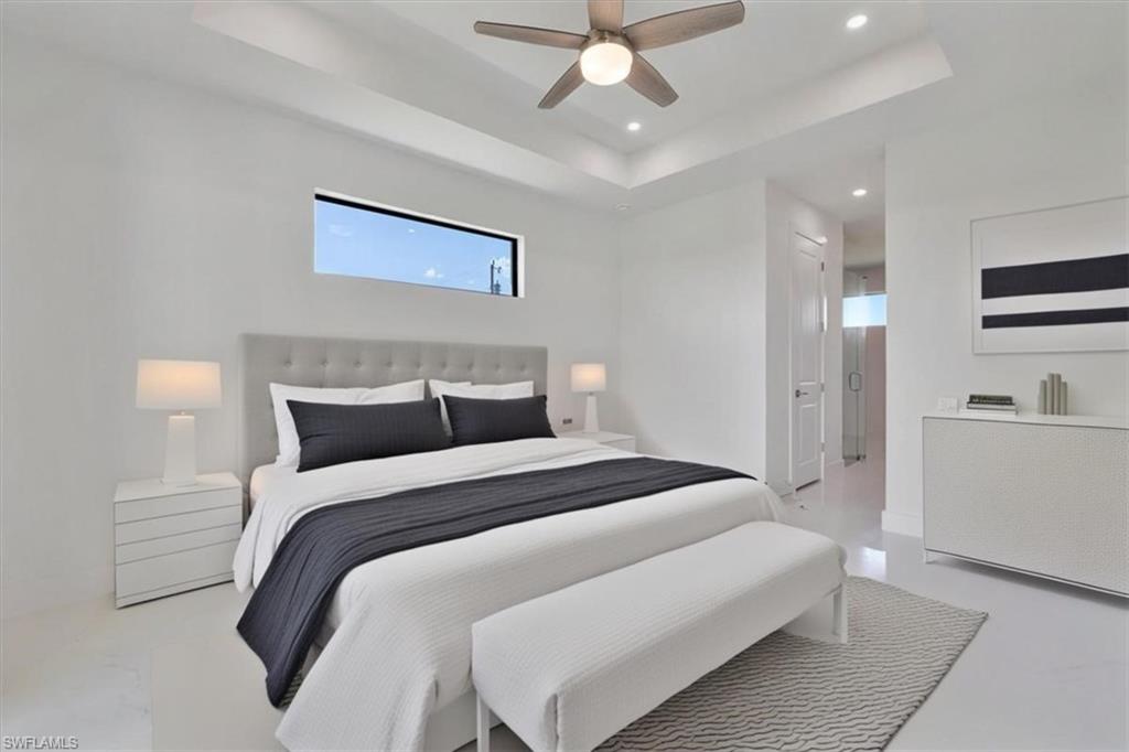 Bedroom featuring recessed lighting, a ceiling fan, and a raised ceiling