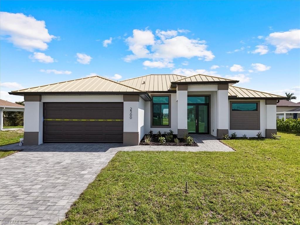 View of front of property with metal roof, stucco siding, and a standing seam roof