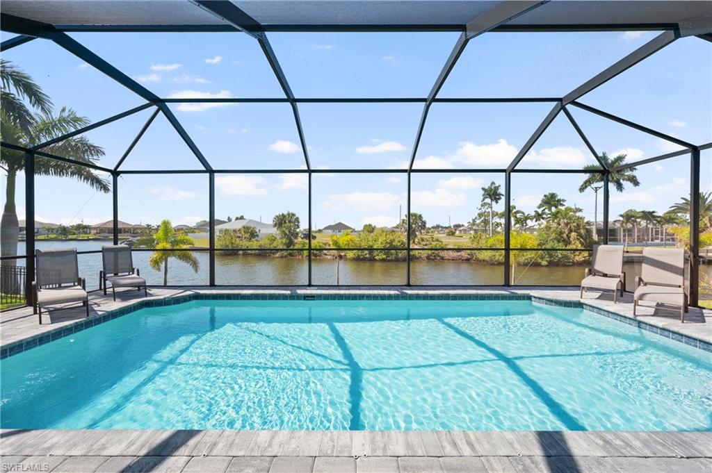 Outdoor pool featuring a water view and a lanai
