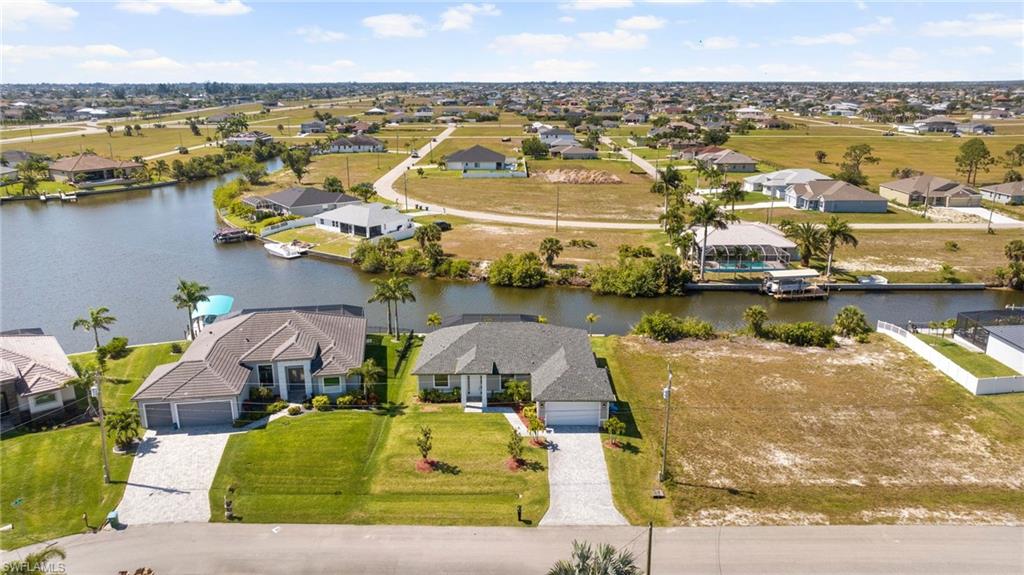 Aerial view featuring a residential view and a water view