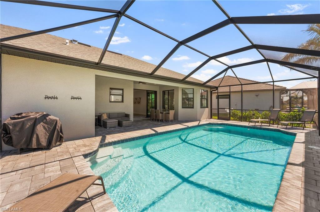 Outdoor pool featuring a lanai, an outdoor living space, a patio area, and a ceiling fan