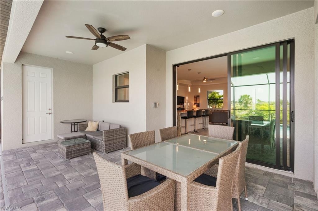 View of patio / terrace with an outdoor living space, outdoor dining area, and a ceiling fan