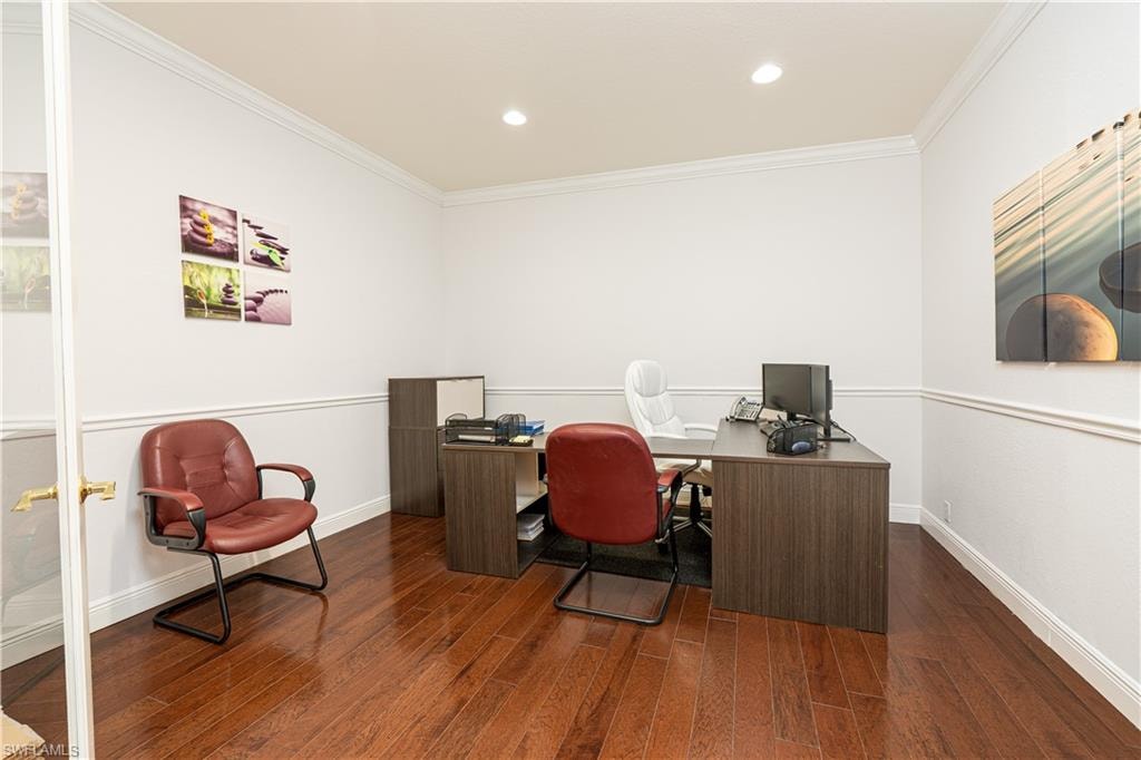 Office with baseboards, crown molding, and wood finished floors