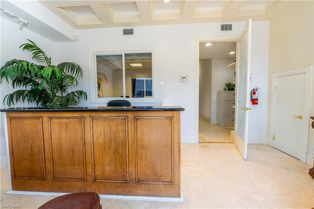 Kitchen with brown cabinets and visible vents